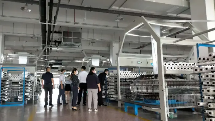 A group of people are visiting the Xifa factory